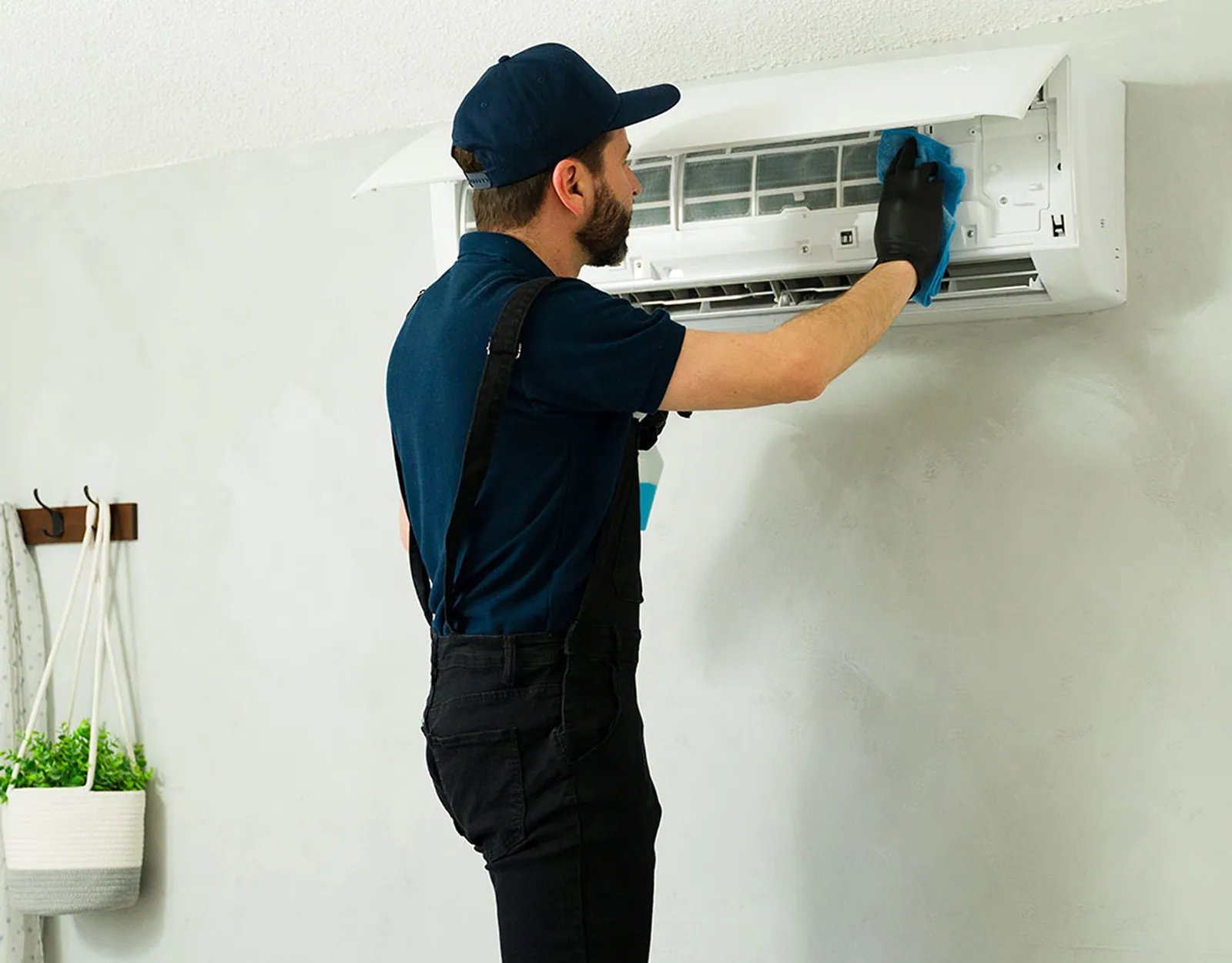 Technician maintaining an air conditioning unit